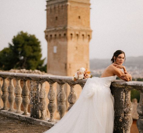 bride in strapless white dress looking out over the grounds at Italian wedding venue Villa Imperiale