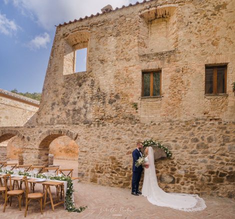 bride and groom stood outside by the cloisters at Italian wedding venue Antico convento i cappuccini di montalcino