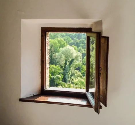 wooden framed window looking out at the grounds at Italian wedding venue Antico convento i cappuccini di montalcino