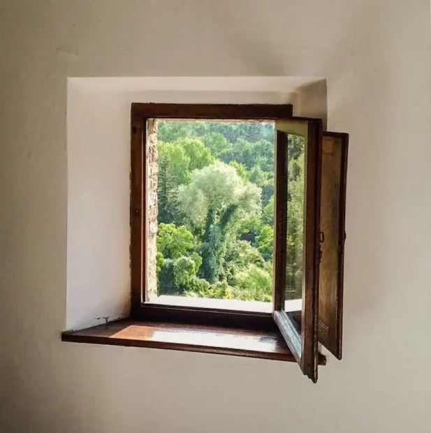 wooden framed window looking out at the grounds at Italian wedding venue Antico convento i cappuccini di montalcino