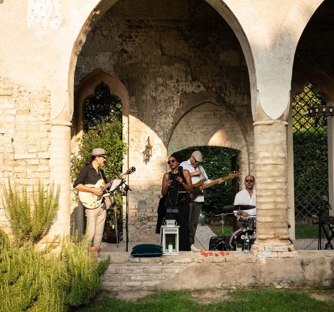 cloisters with musicians performing under