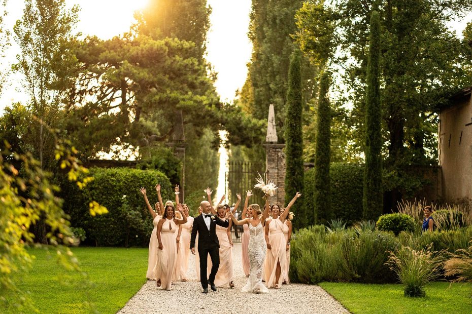bridal party all walking towards the camera through the grounds at Italian wedding venue convento dell'annunciata