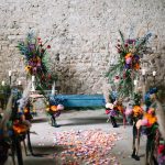 neon bright florals lining the aisle at Italian wedding venue convento dell'annunciate