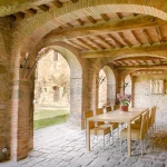 wedding table under the cloisters at Italian wedding venue Antico convento i cappuccini di montalcino
