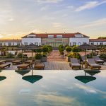view of pool with umbrella reflection at luxury wedding venue in portugal Quinta da Comporta