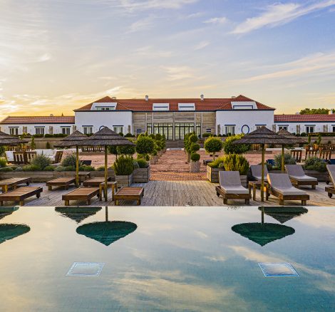 view of pool with umbrella reflection at luxury wedding venue in portugal Quinta da Comporta