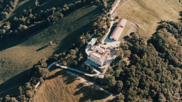 aerial view over le stonghe estate wedding venue in marche italy