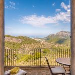 view out of double doors across the mountains towards the sea at exclusive wedding venue in Mallorca Ca's Xorc