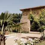 stone exterior of fortified medical farmhouse turned wedding venue in south of France le petit roulet
