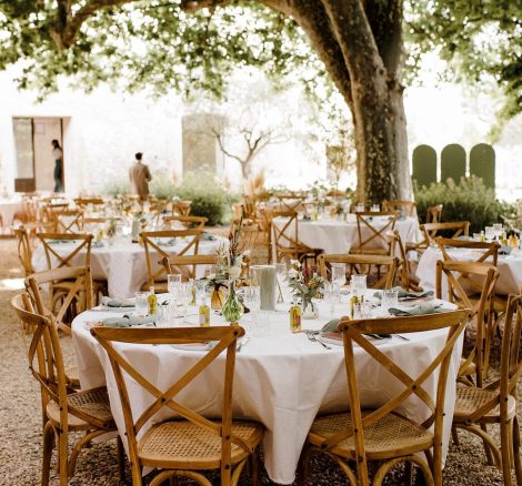 round wedding tables set up in the courtyard wedding venue in south of France le petit roulet