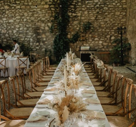 view up along wedding tables set up with neutral boho florals at le Petit Roulet wedding venue in luberon in france