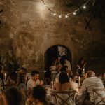 wedding guests celebrating whilst dining outside at le Petit Roulet wedding venue in luberon in france