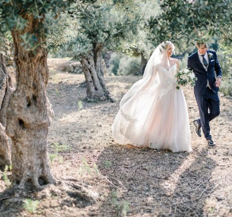 bride and groom walking through th olive groves at luxury wedding venue ca's xorc in mallorca