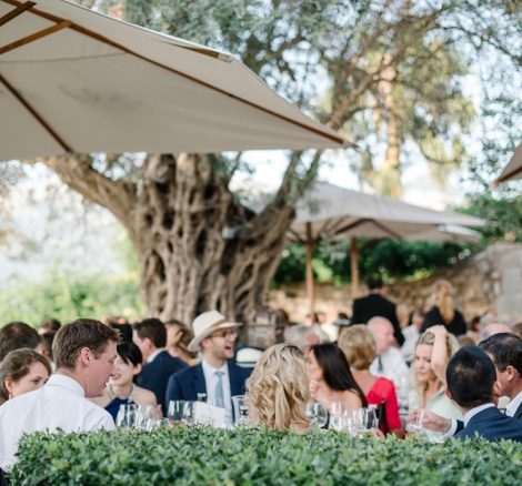 wedding guests dining al fresco under umbrellas at luxury wedding venue ca's xorc in mallorca