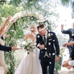bride and groom confetti shot as they leave hand in hand down the outdoor aisle at luxury wedding venue ca's xorc in mallorca