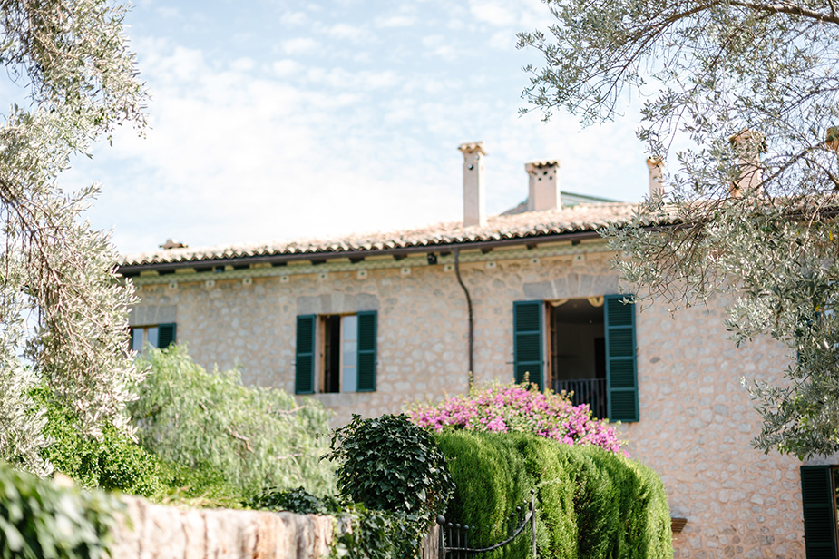 stone exterior with green Mallorca finca style windows at luxury wedding venue ca's xorc in mallorca