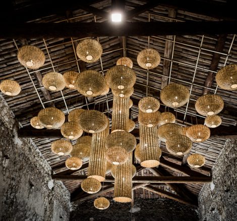 hanging rattan lights from pitched roof of barn at le Petit Roulet wedding venue in france