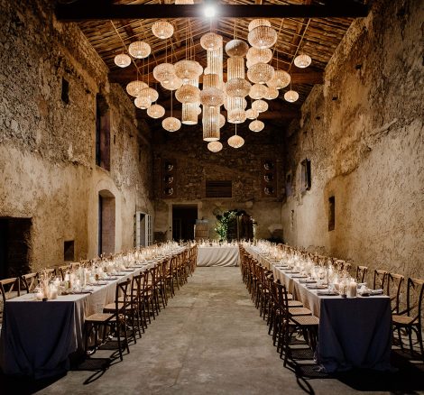 long rectangular tables in gran barn with high ceilings at le Petit Roulet wedding venue in luberon in france