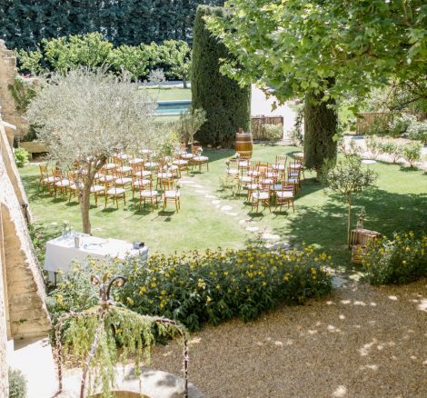 angled ceremony set up on the lush grounds at le Petit Roulet wedding venue in luberon in france