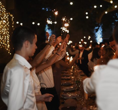 wedding guests with sparklers dining al fresco at le Petit Roulet wedding venue in south of france