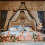 bridal suite with fabric draped behind the bed at unique wedding venue in Cyprus liopetro