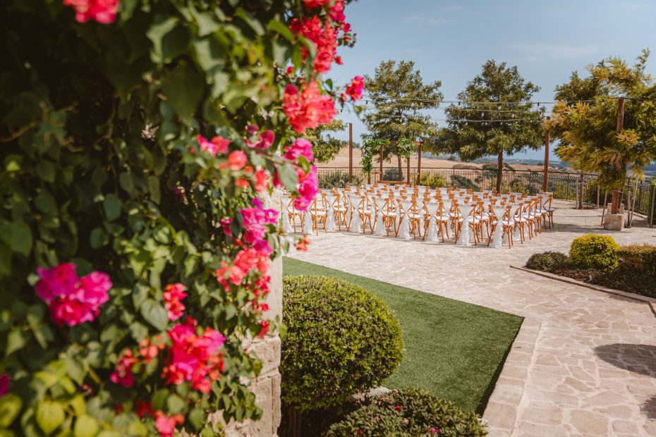 wedding ceremony set up with wooden chairs at liopetro a stunning wedding venue in Cyprus
