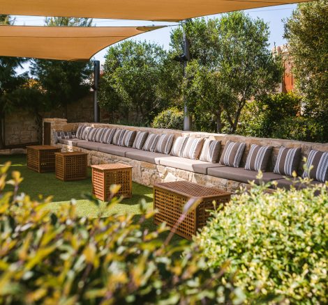 long seating area under parasols at wedding venue in Cyprus liopetro