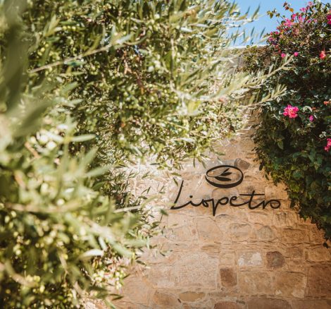 entrance sign on stone wall at wedding venue in Cyprus liopetro
