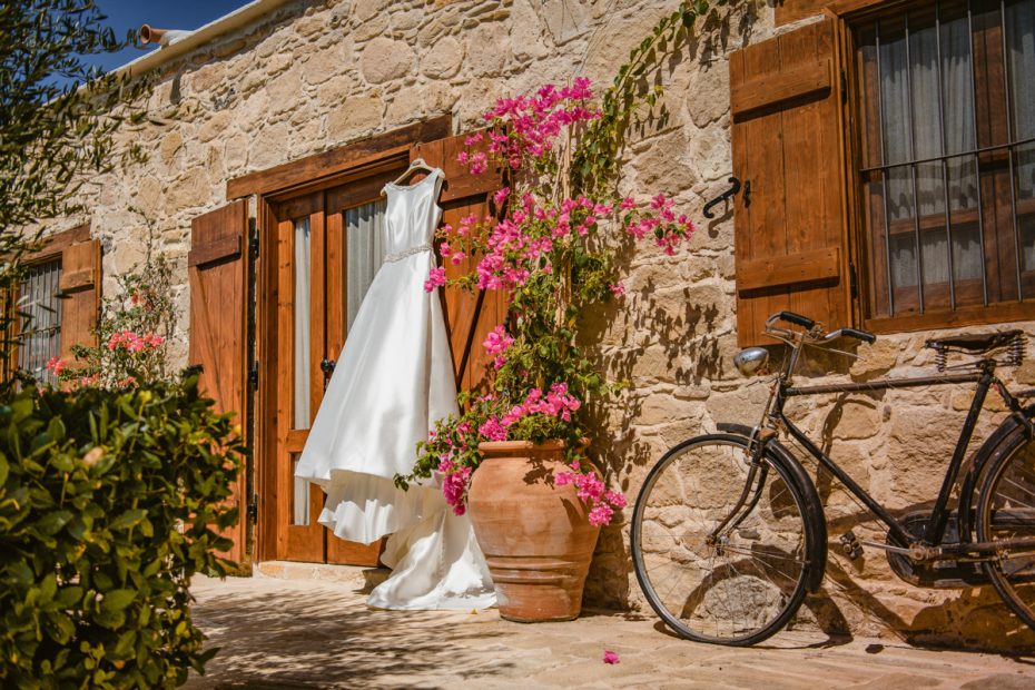 brides dress hung outside the entrance to Cyprus wedding venue