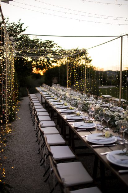 long wedding tables with wooden chairs and white seat cushions