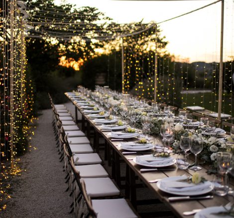 long wedding tables with wooden chairs and white seat cushions