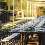 wooden tables and fold out black chairs at wedding venue in umbria italy