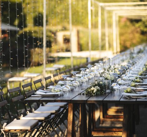 wooden tables and fold out black chairs at wedding venue in umbria italy