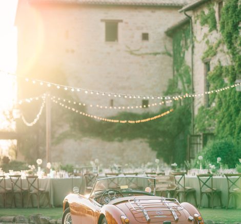 red old classic wedding car at wedding venue in italy castello di petrata in umbria