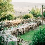 wooden chairs and winding curved tables at wedding venue in italy castello di petrata