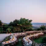 curved wedding tables outside on the grounds at wedding venue in italy castello di petrata in umbria