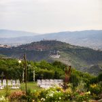 wedding ceremony qith backdrop of green hills in umbria at unqiue wedding venue in italy