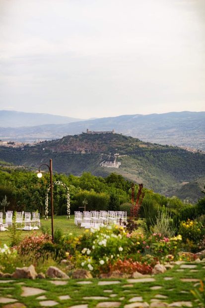 wedding ceremony qith backdrop of green hills in umbria at unqiue wedding venue in italy