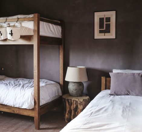 stylish farmstay style bedroom with bunk beds at wedding venue Borgo Castello Panicaglia