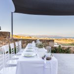 white linen table cloth ver long rectangular table at the secret view wedding venue in paros greece