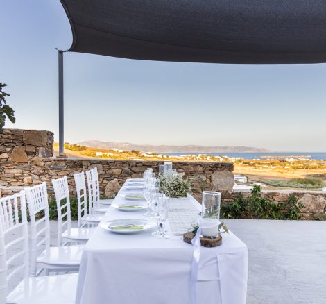 white linen table cloth ver long rectangular table at the secret view wedding venue in paros greece