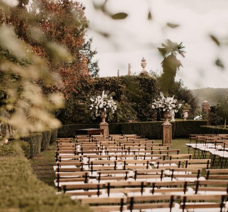 wooden chairs set up for ceremony outside at wedding venue in Tuscany Italy Borgo Stomennano