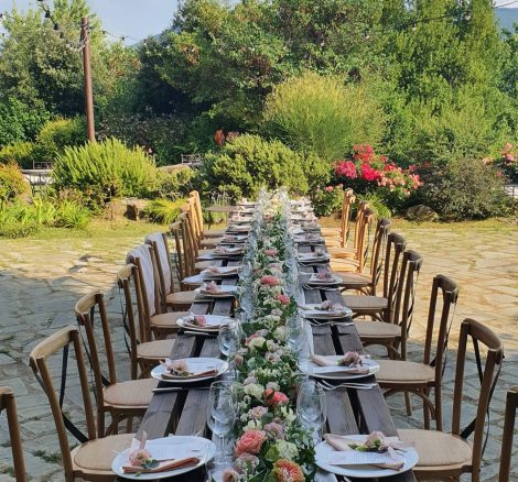 long rectangular wedding table with vibrant coloured flowers down the centre at wedding venue in italy castello di petrata