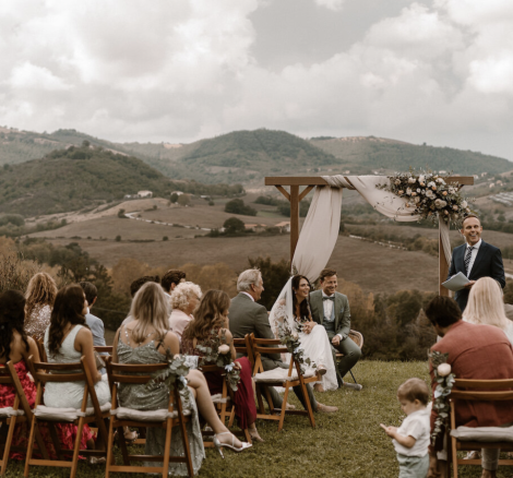 wedding guests seated for an outdoor ceremony at wedding venue Borgo Castello Panicaglia