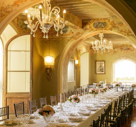 long tables inside under arched ceiling at wedding venue in Tuscany Italy Borgo Stomennano