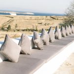 grey cushions along low level wall at fladakia estate in paros greece