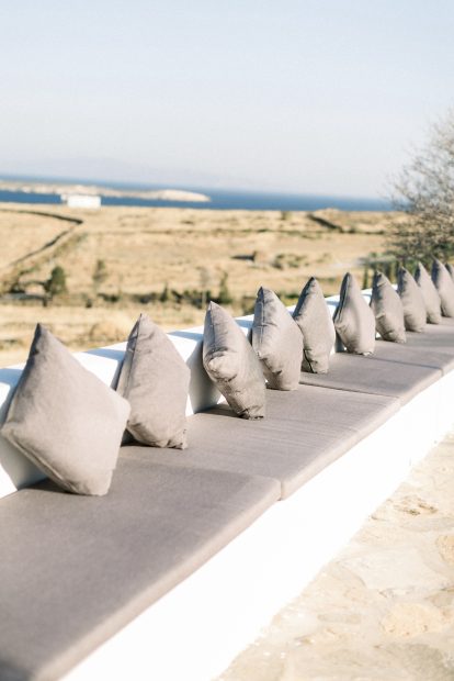 grey cushions along low level wall at fladakia estate in paros greece