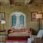 quaint historic furnishings and bridal dress hung up at wedding venue in Tuscany Italy Borgo Stomennano