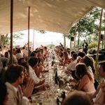 wedding guests dining in open air marquee at le grand banc luxury destination wedding venue in france
