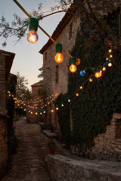 fairy lights outside rustic building at le grand banc luxury destination wedding venue in france